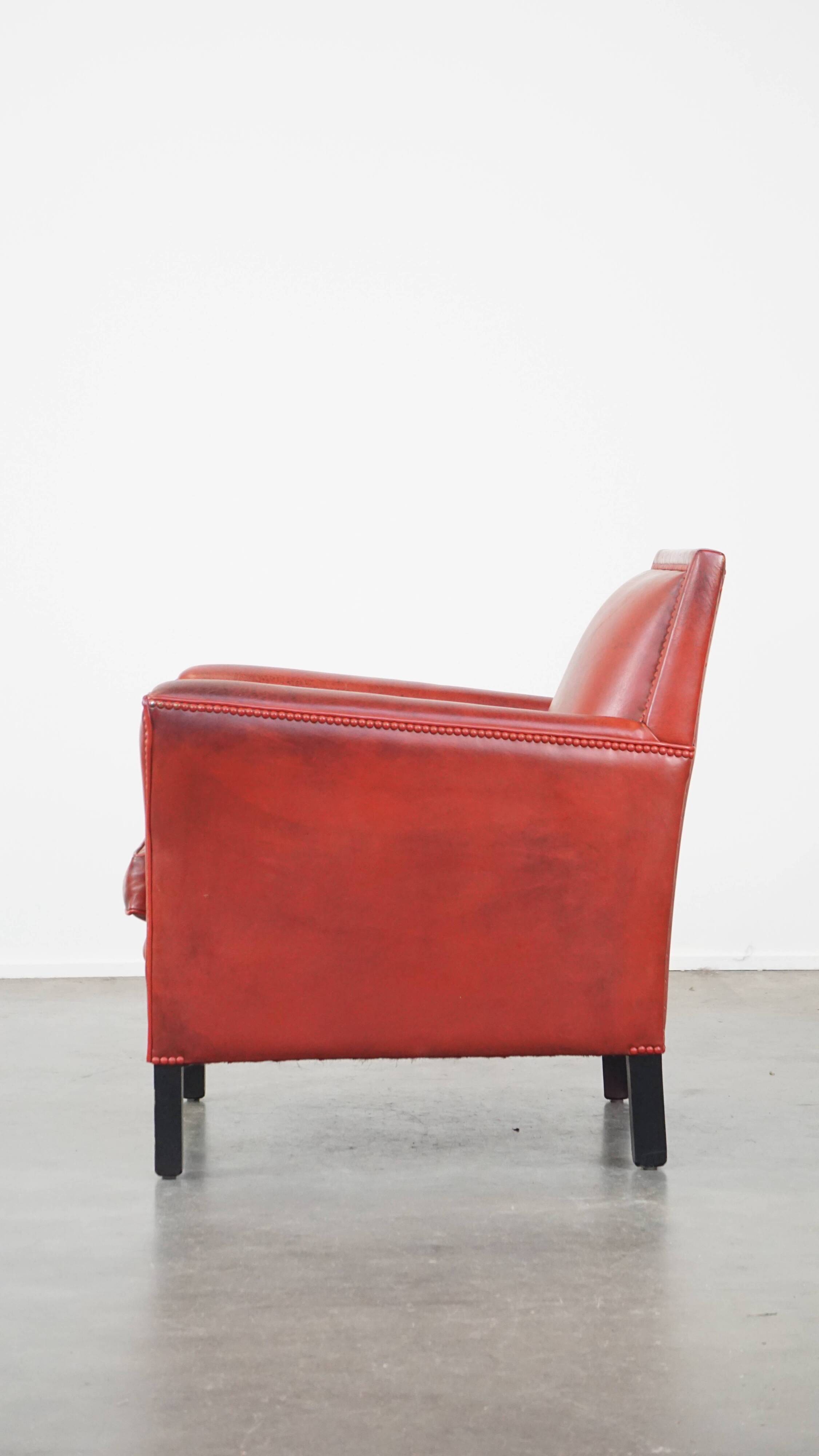 Red-painted armchair made of sheepskin leather