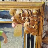 Large mirror with beveled facets in gilded wood from the early 20th century