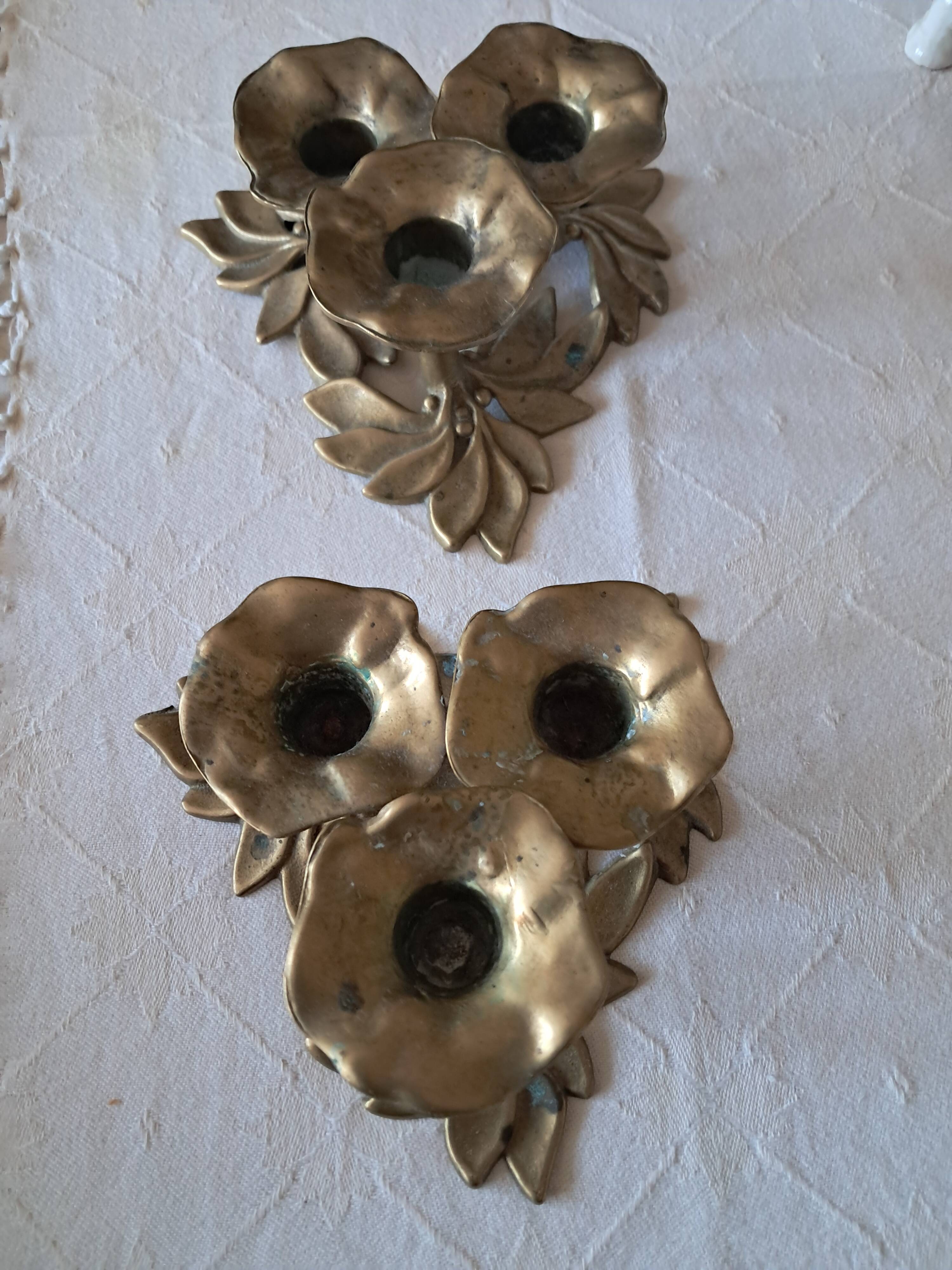 Pair of antique three-branch candlesticks with a floral design.