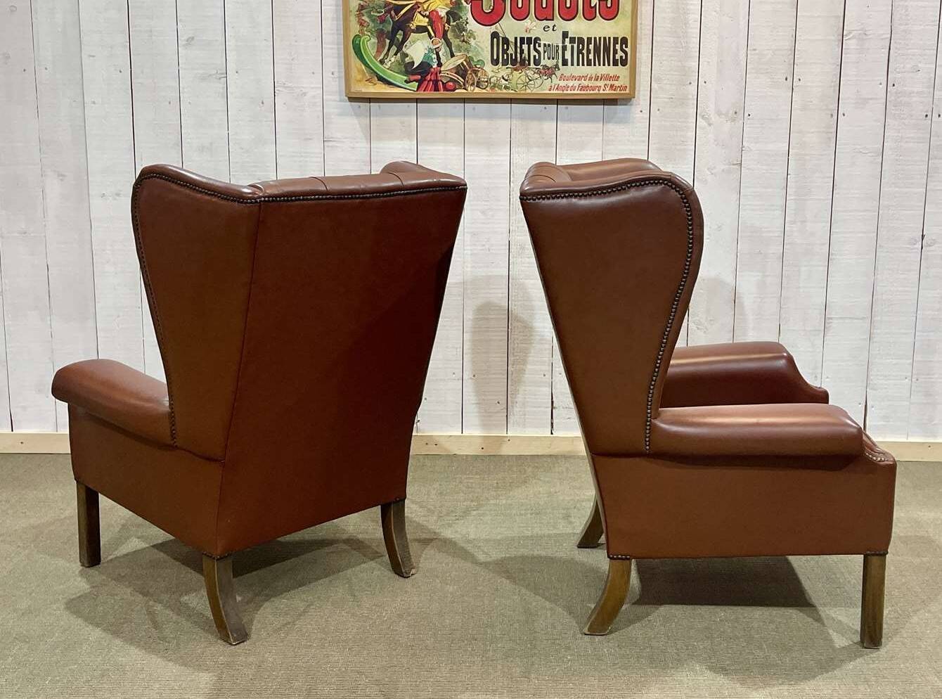 Pair of brown leather wingback Chesterfield armchairs from the 1970s.