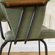 Vintage chair with green imitation leather armrests