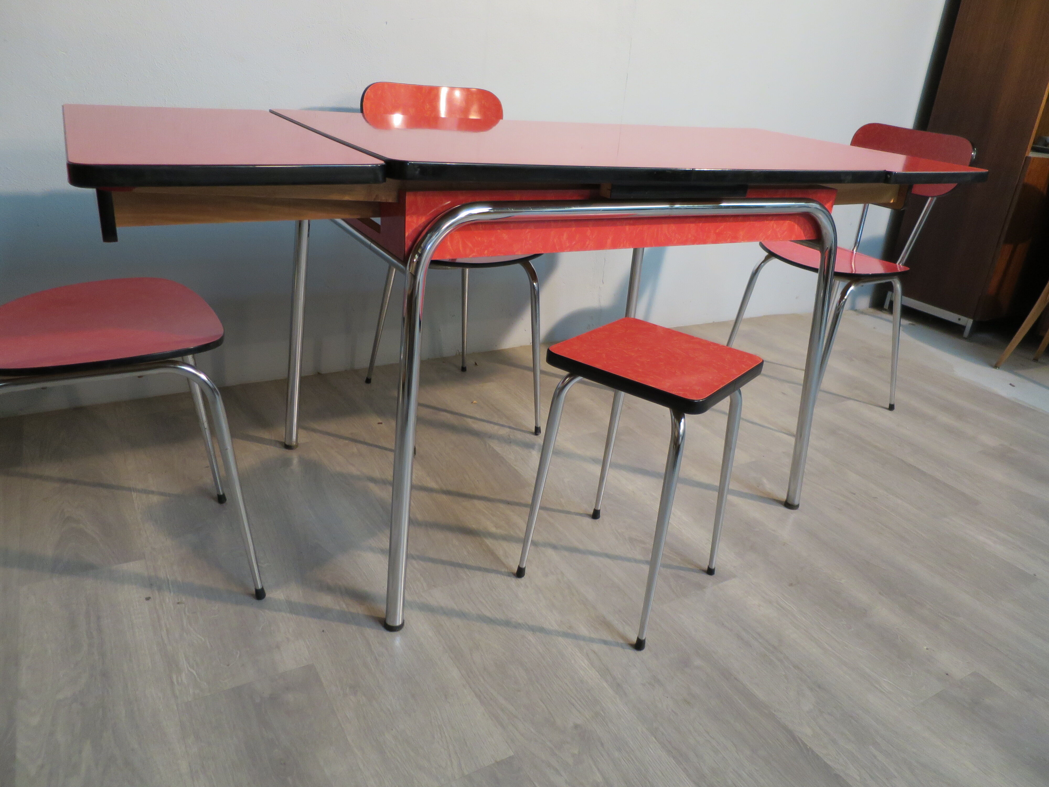 Table, 3 chairs and red formica stool