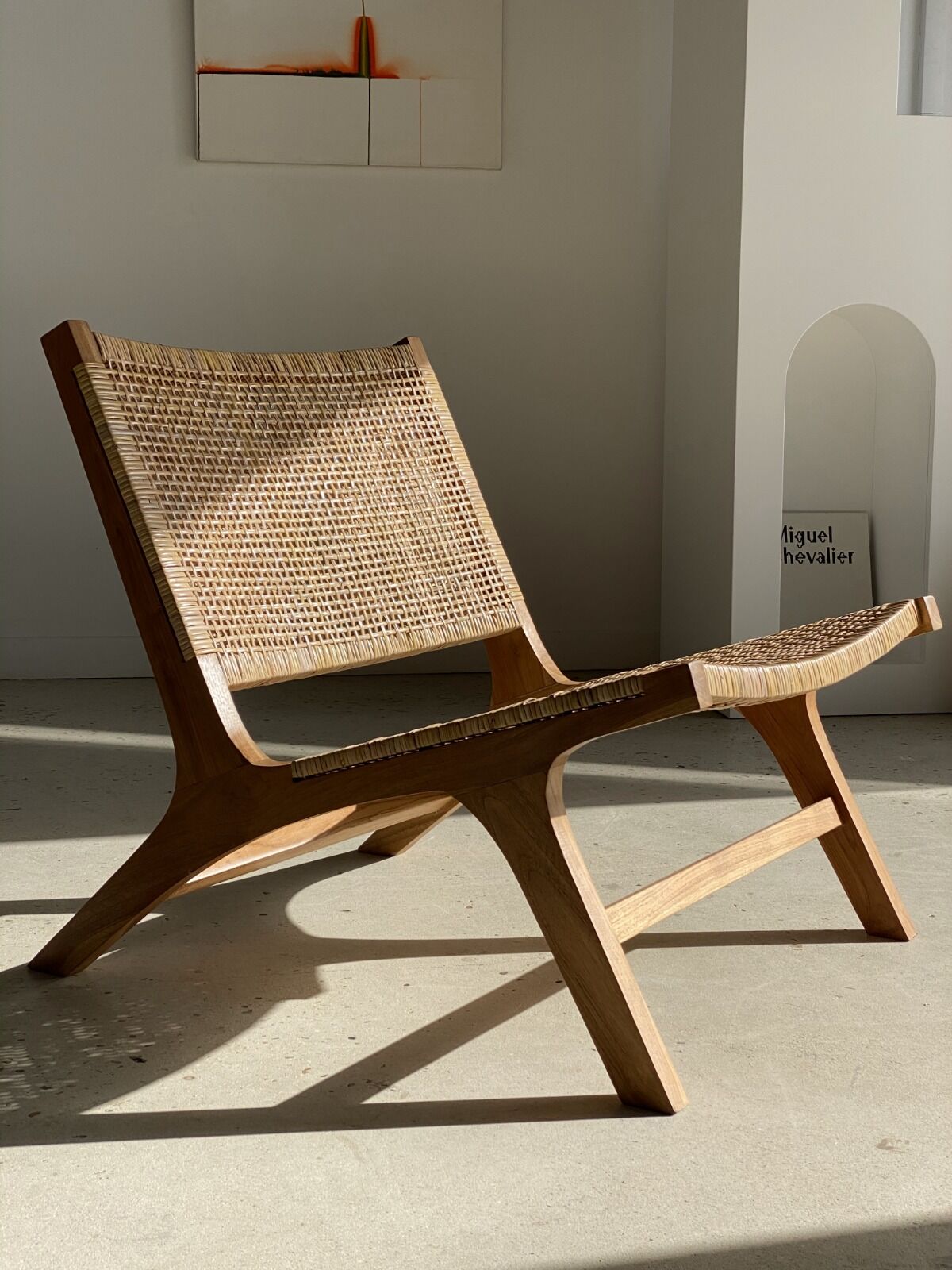 Reclining armchair in natural wood and woven rattan