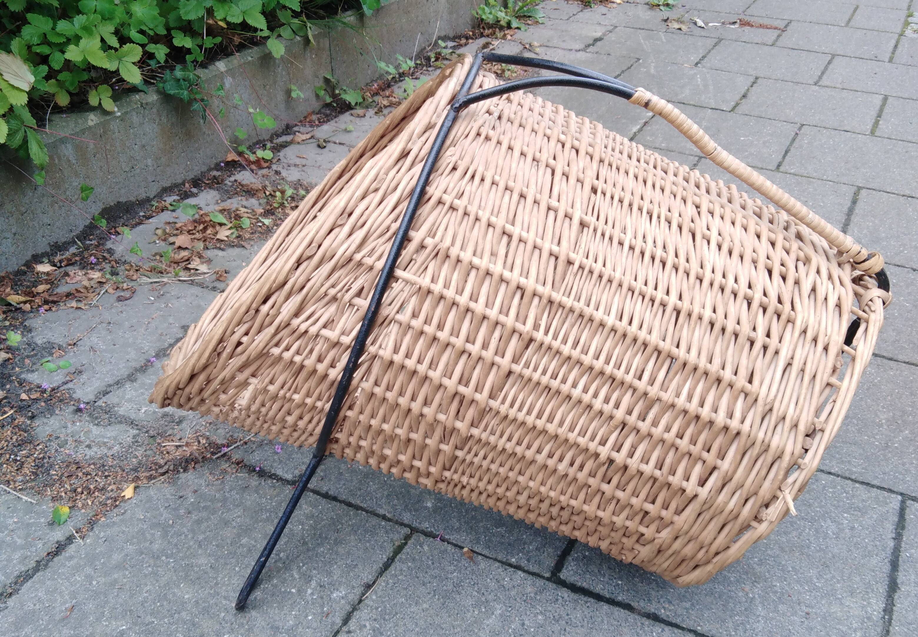 scandinavian  midcentury magazine holder in wicker and with metall legs