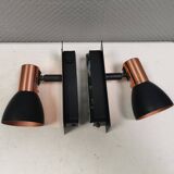 A pair of wall lamps from Eglo, in copper color and black.