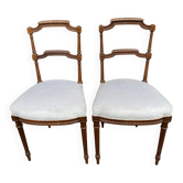 2 Louis XVI period chairs in solid wood and grey fabric.