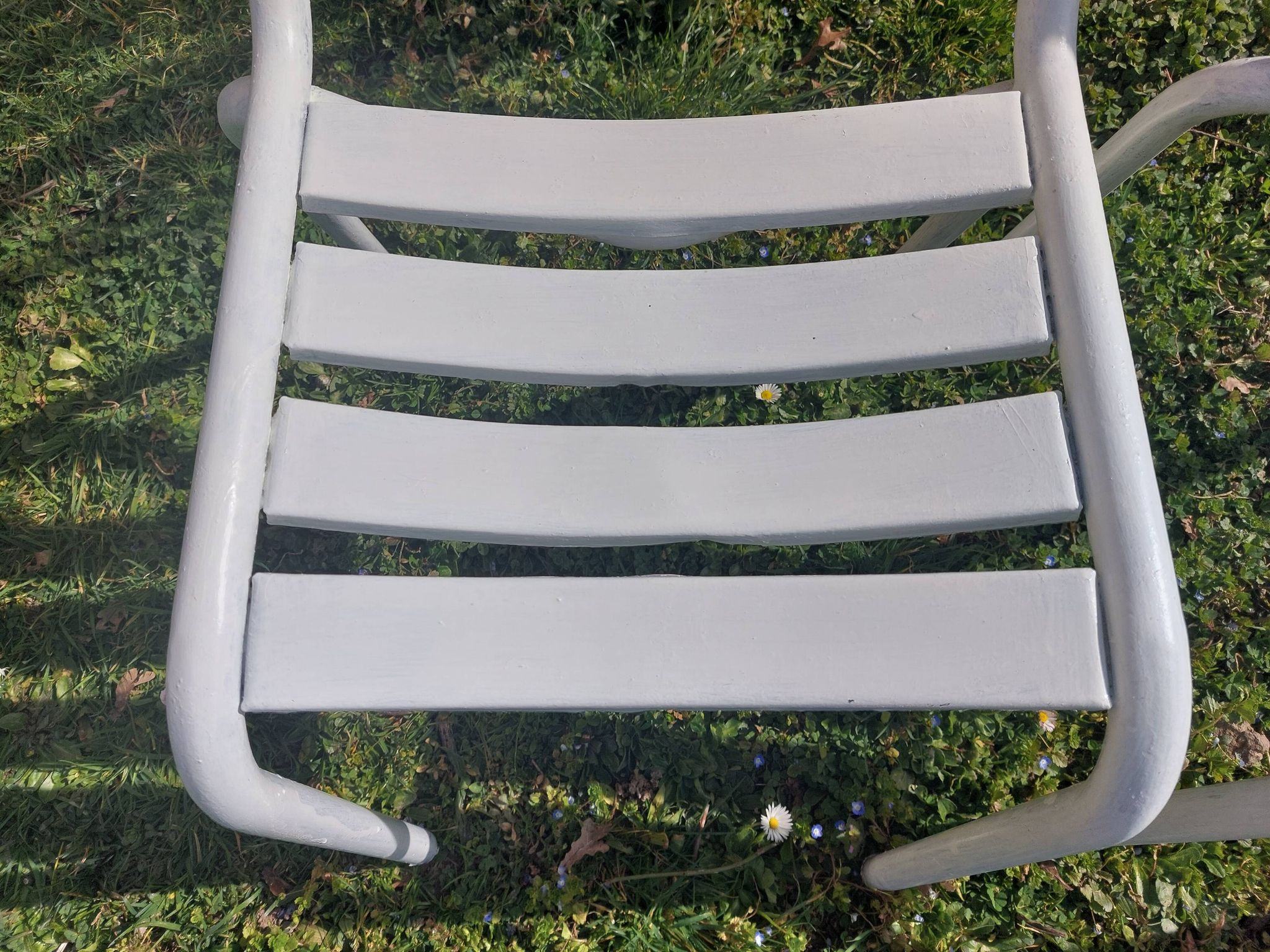 pair of white metal chairs, Tolix style