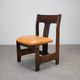 Vintage German sculptural chair from the 1970s in wood with orange faux leather.