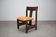 Vintage German sculptural chair from the 1970s in wood with orange faux leather.