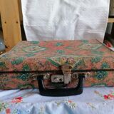 Old suitcase, red cashmere fabric, bohemian folk