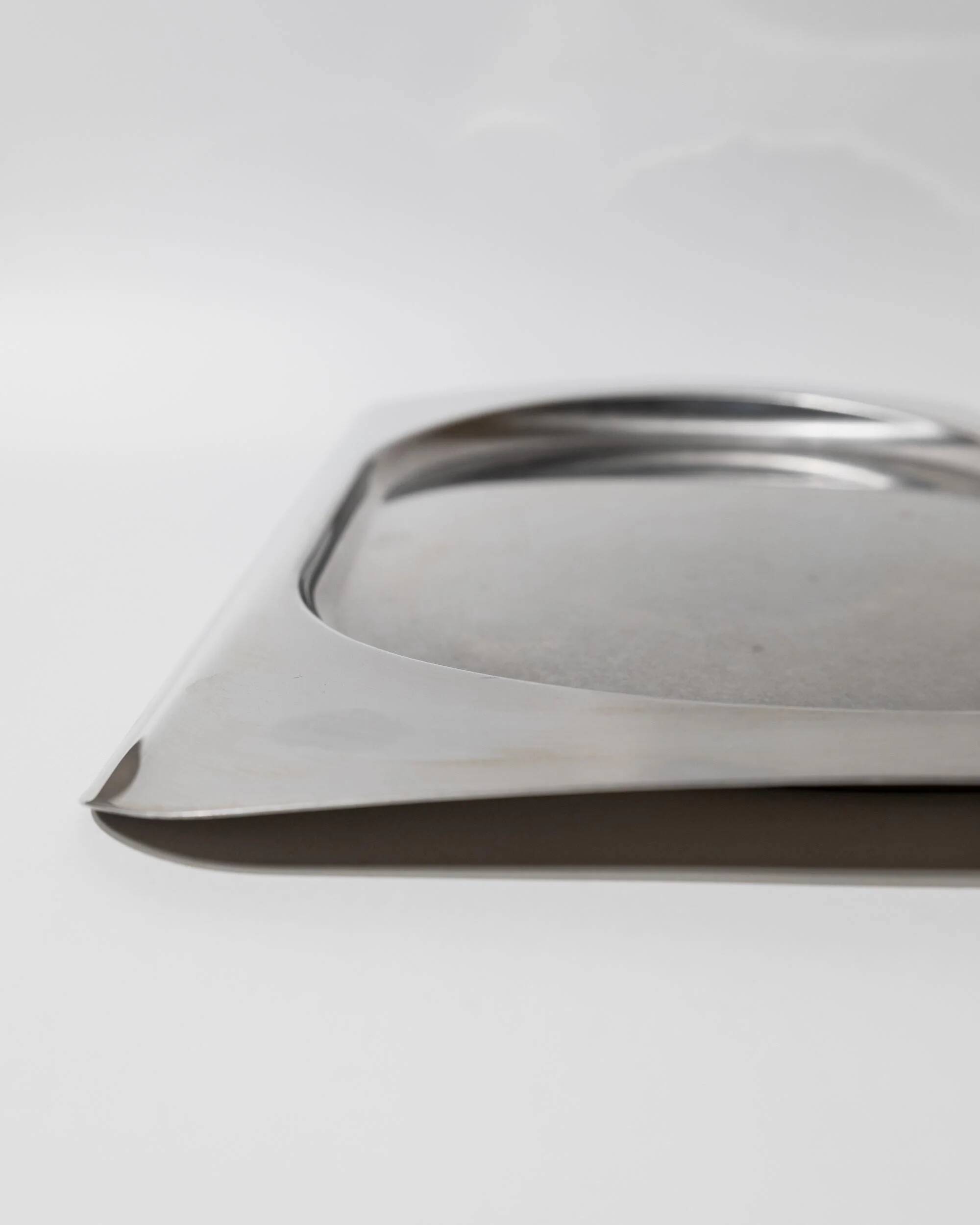 1990s vintage stainless steel platter, rectangular with an oval indentation, minimalist modern design.