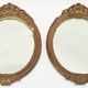 Pair of oval wooden windows with golden patina