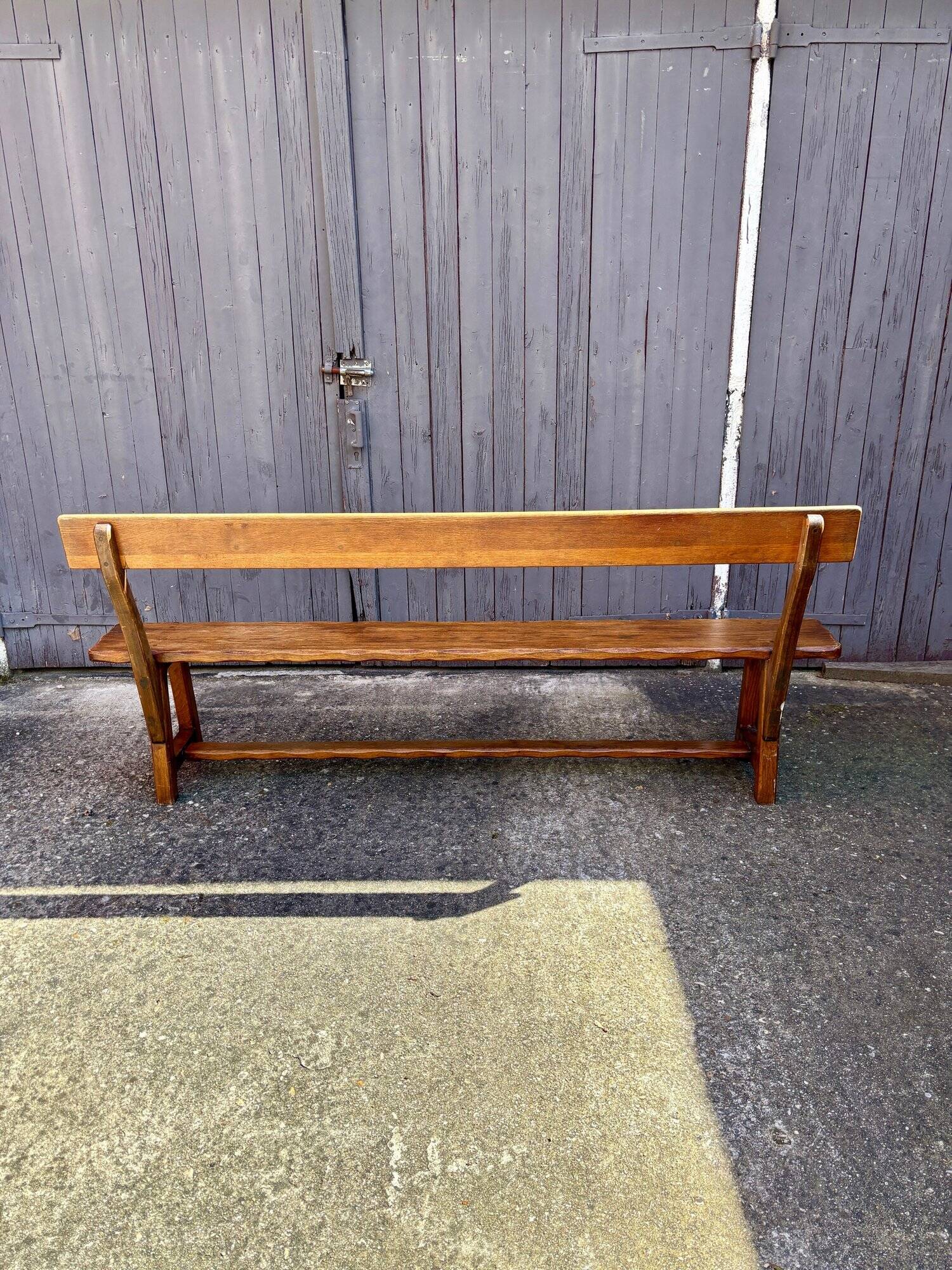 Brutalist bench with dark wood back