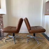 Pair of cognac-colored swivel armchairs