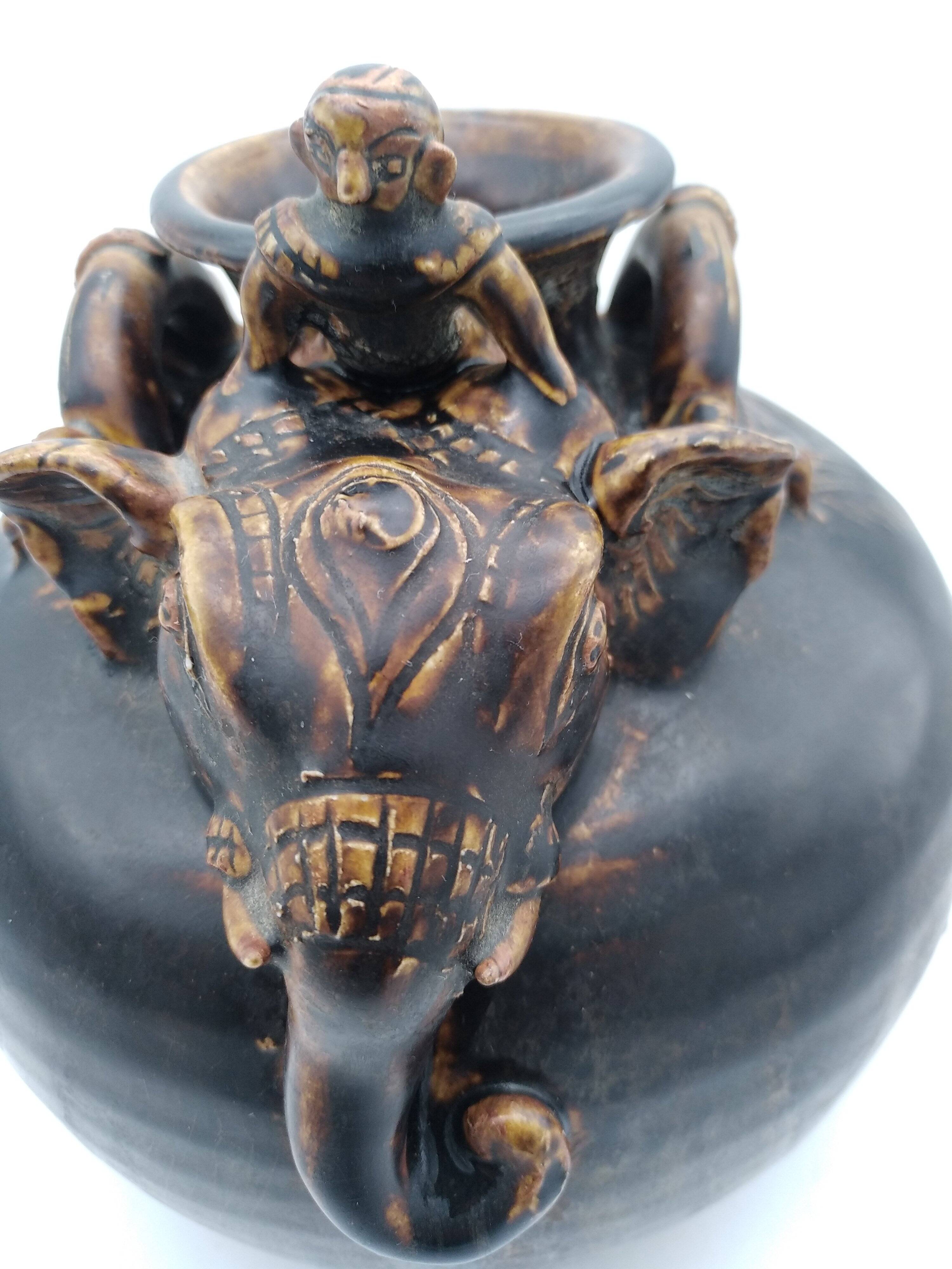 Antique Khmer ceramic vase. With elephant decoration.