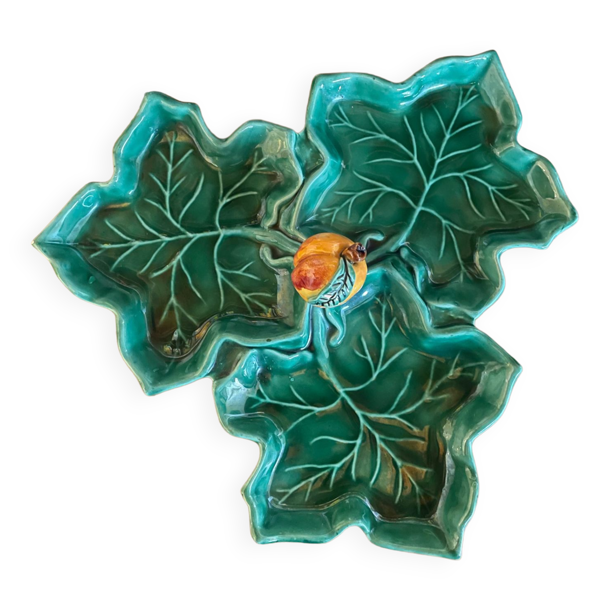 Old dish in green slip decor 3 vine leaves and an apple