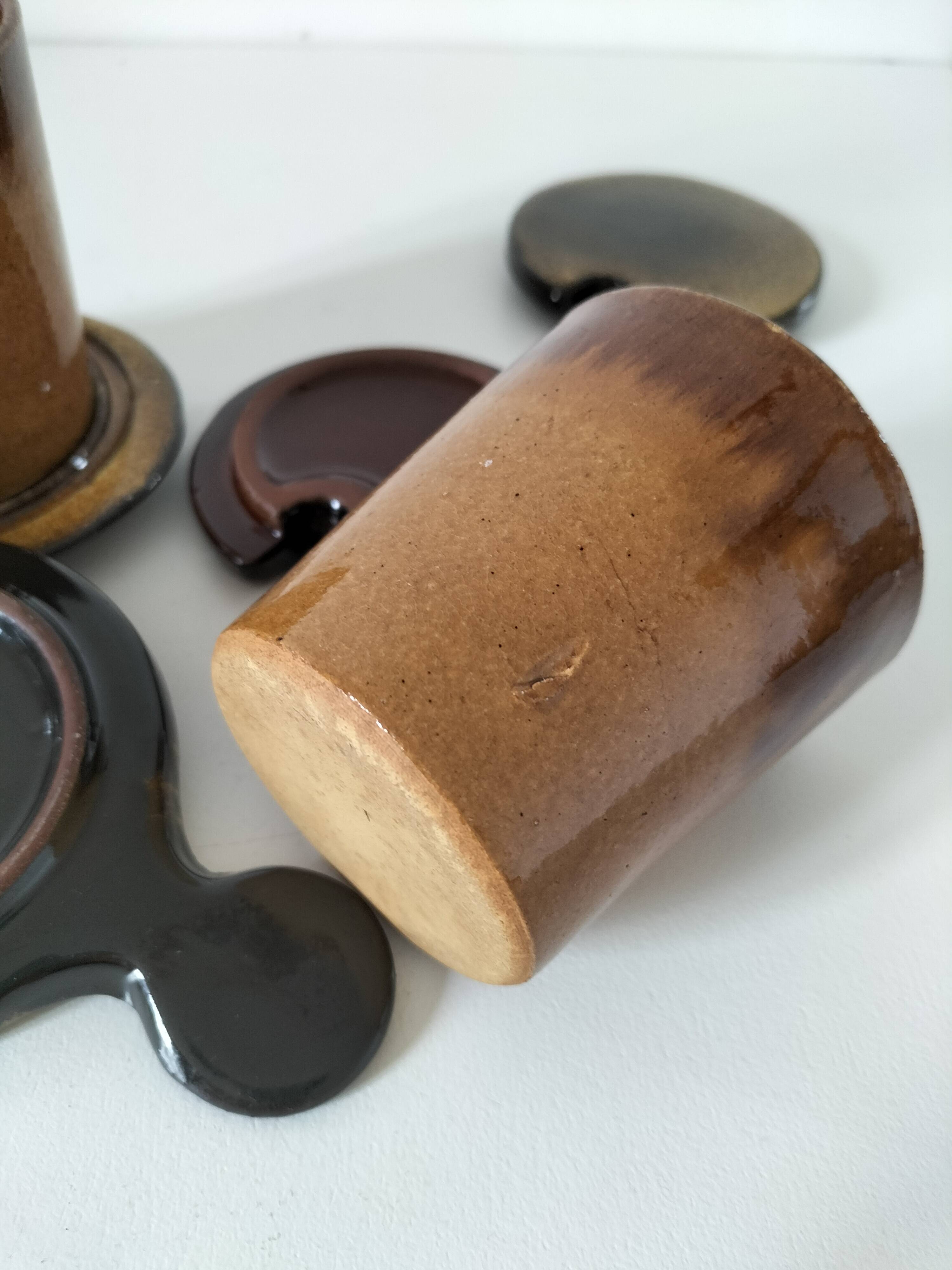 Pair of glazed stoneware cups with saucers and lids