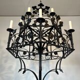 Lustre with 12 lights in wrought iron decorated with clovers and foliage.