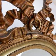 Wear consistent with age and use Wood and gilded plaster "Noeud d'Amour" Oval mirror
