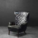 Vintage Danish modern wingback chair in black quilted leather, mid-20th century, 1960s.