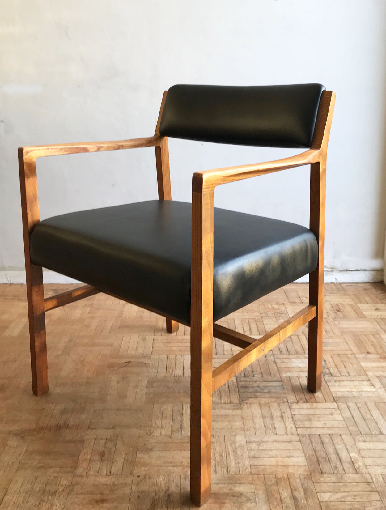Chair in light teak and black skaï from the 1960s