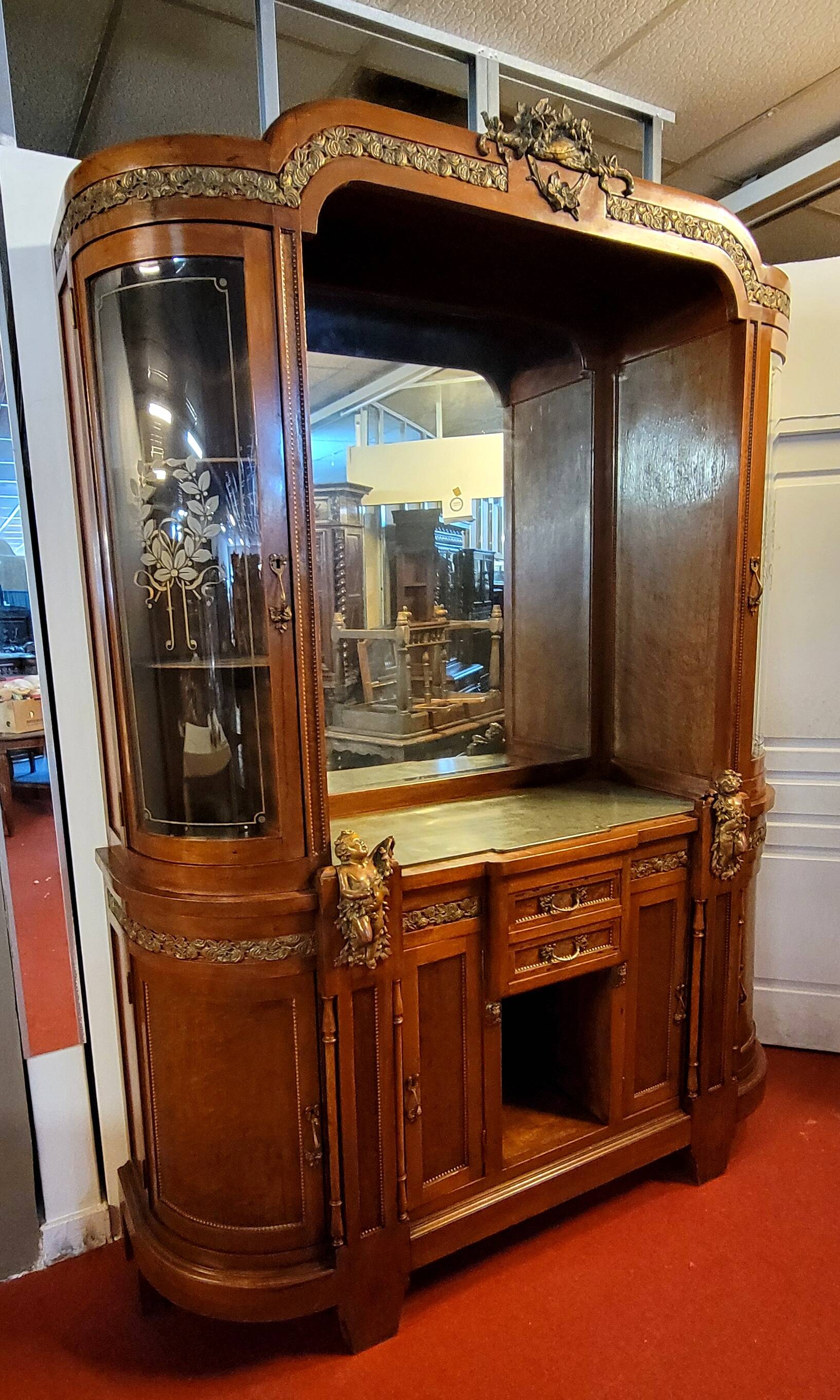 Empire style half-moon shaped mahogany bookcase with putti