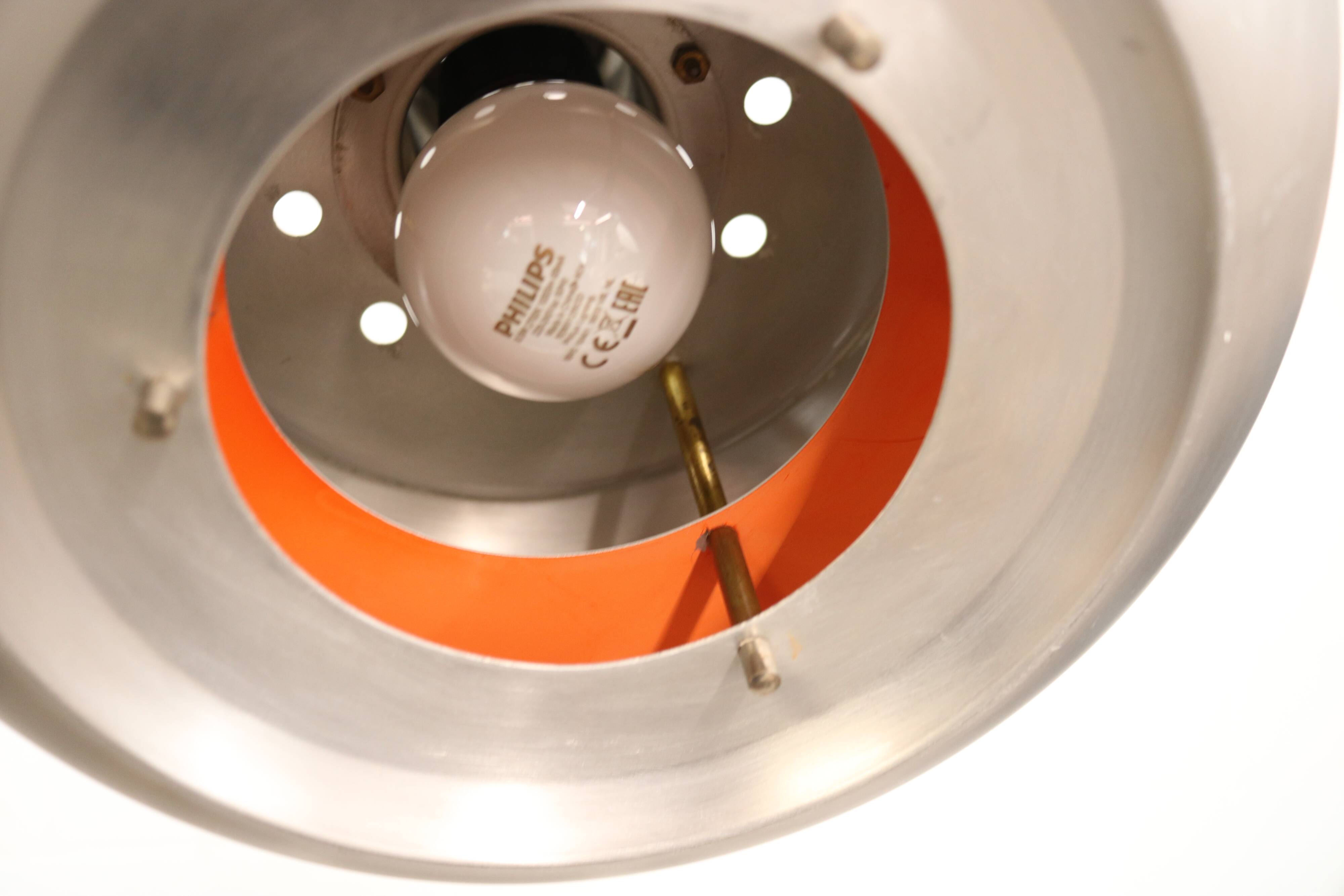 Old Danish space age design lamp in alu and orange inside.