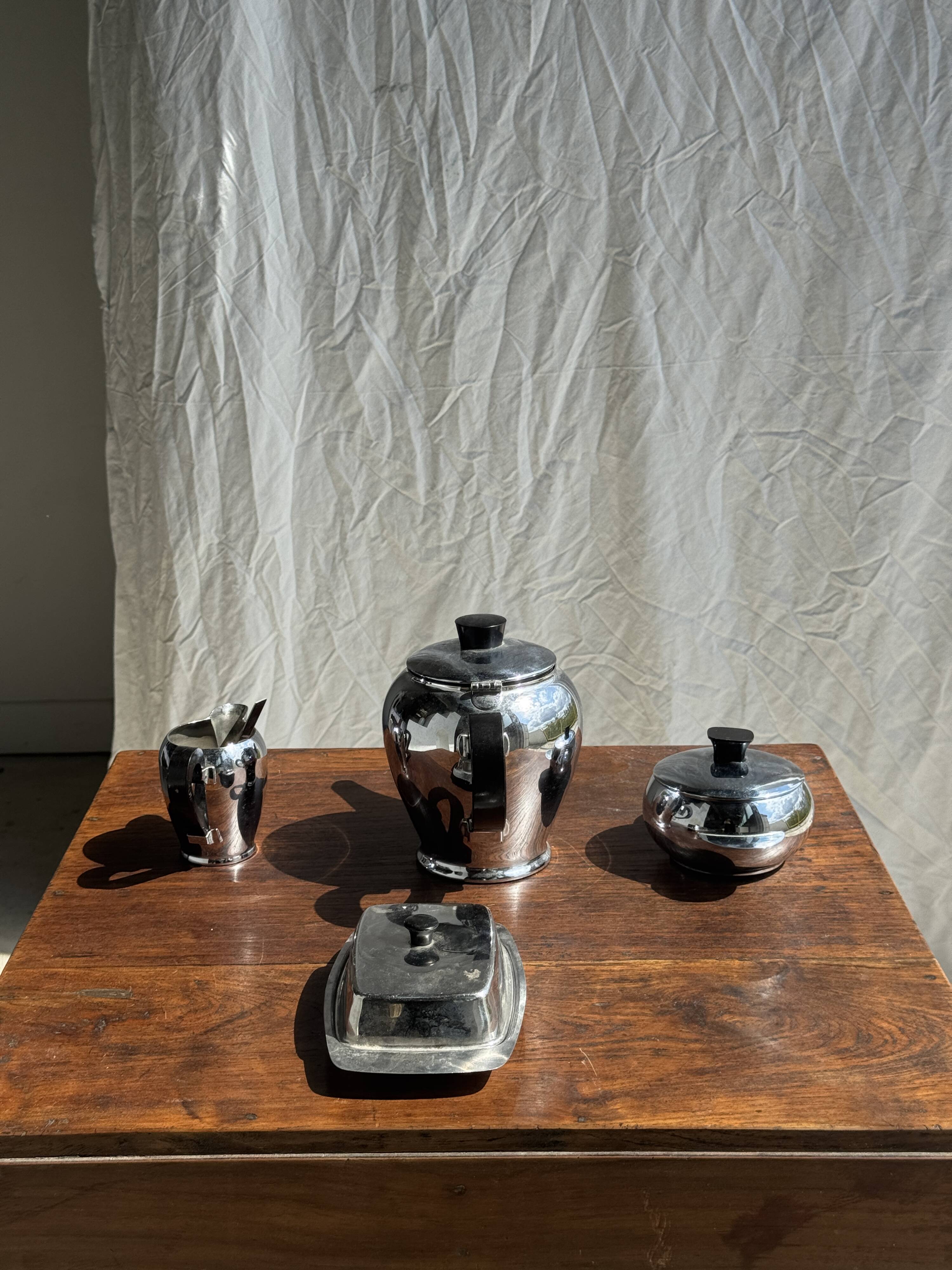 Tea set including teapot, milk jug, sugar bowl and butter dish