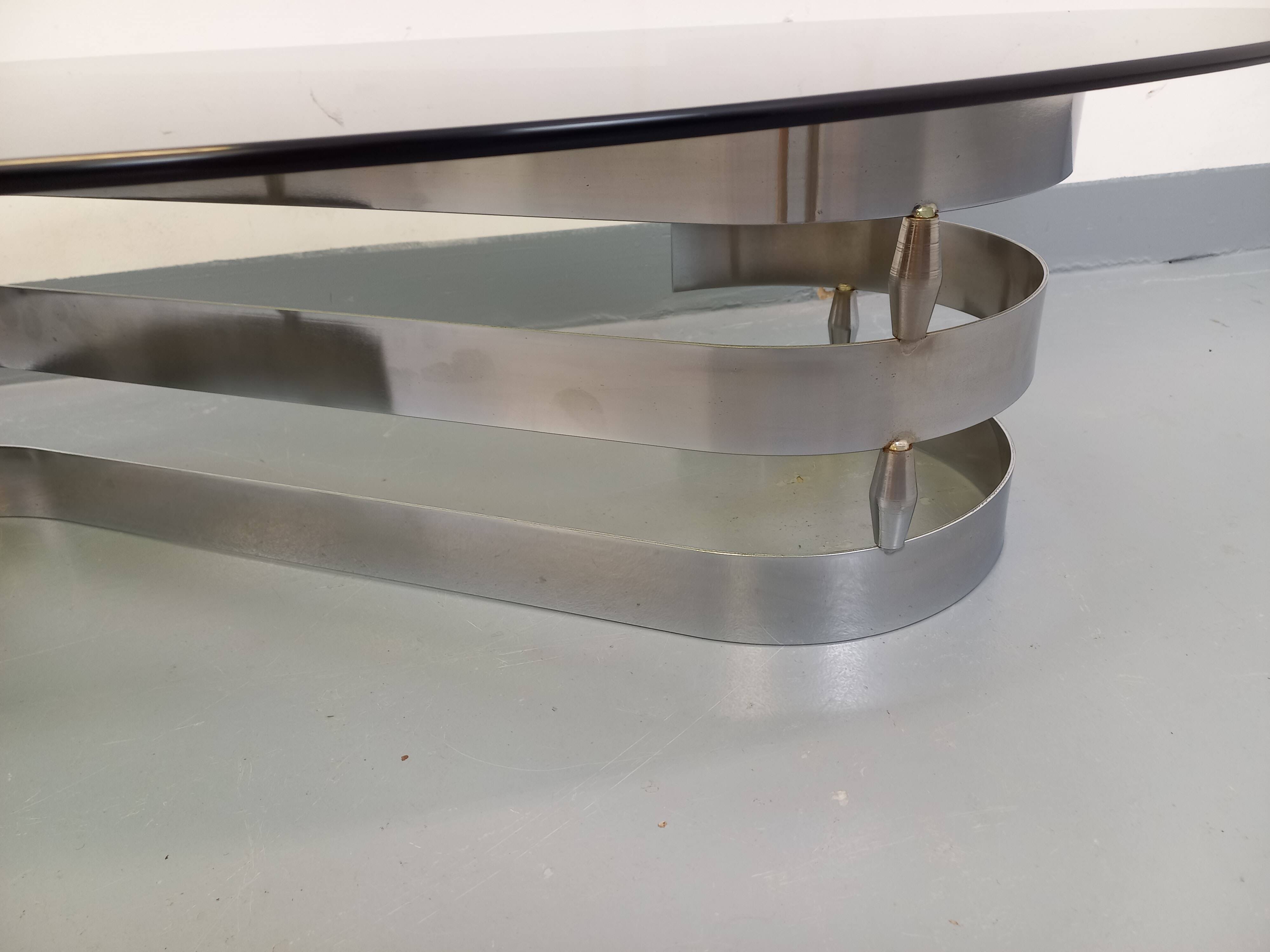 Vintage oval coffee table in smoked glass and chrome metal from the 1970s.