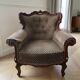 Baroque armchair in carved wood and geometric fabric.