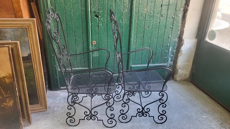 Pair of black wrought iron armchairs