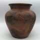 Vase or pot in brown terracotta with artistic decoration of fish.