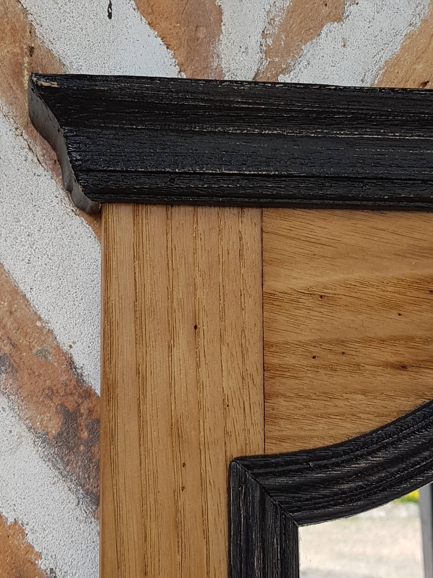 Black mirror and raw natural wood