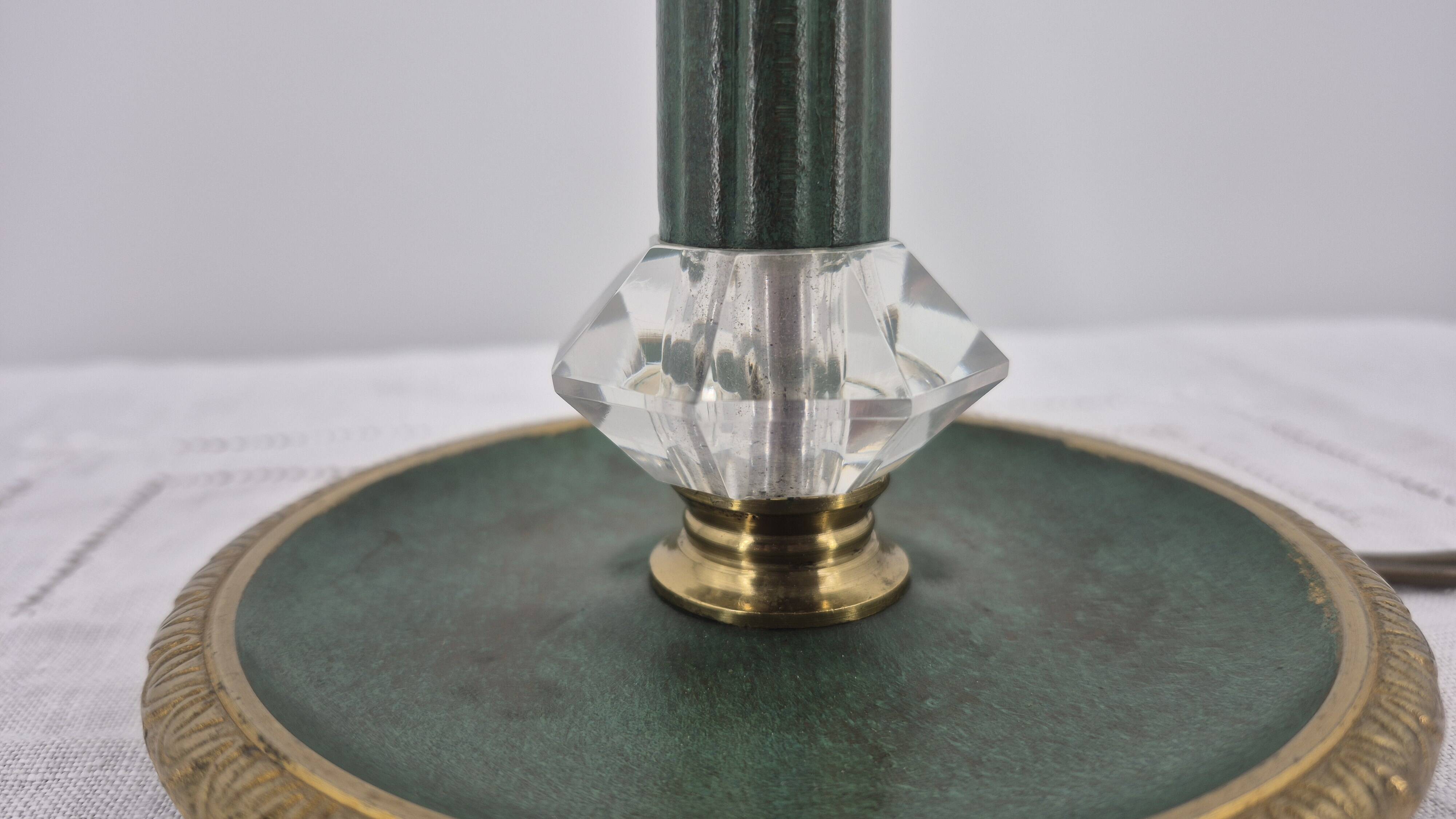 Brass table lamp with green patina and empire-style fabric shade.