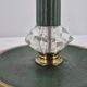 Brass table lamp with green patina and empire-style fabric shade.