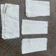 4 serviettes en lin teintées jaune pastel, monogrammées AL