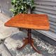 19th-century solid mahogany table with a tilting top and brass mechanism.