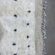 White wool mat with stitches