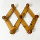 Accordion wall coat rack in solid pine