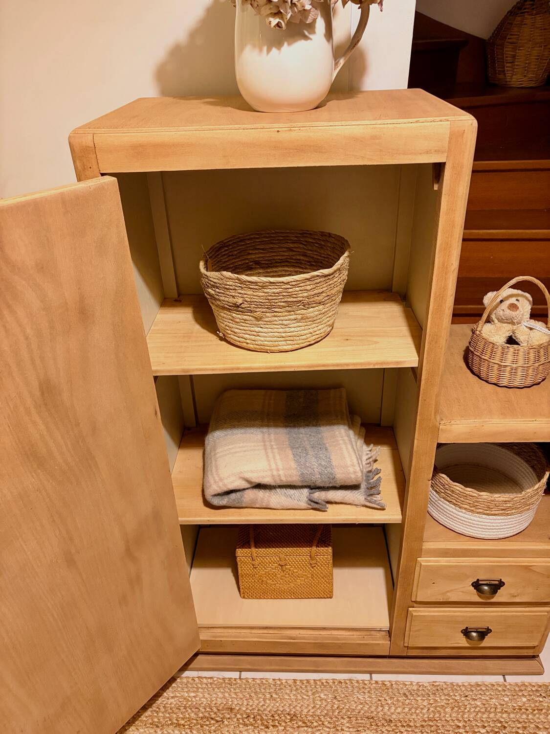 Asymmetrical cabinet made of raw wood