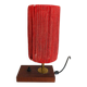 Small lamp made of wood, brass, and wool.