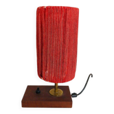 Small lamp made of wood, brass, and wool.