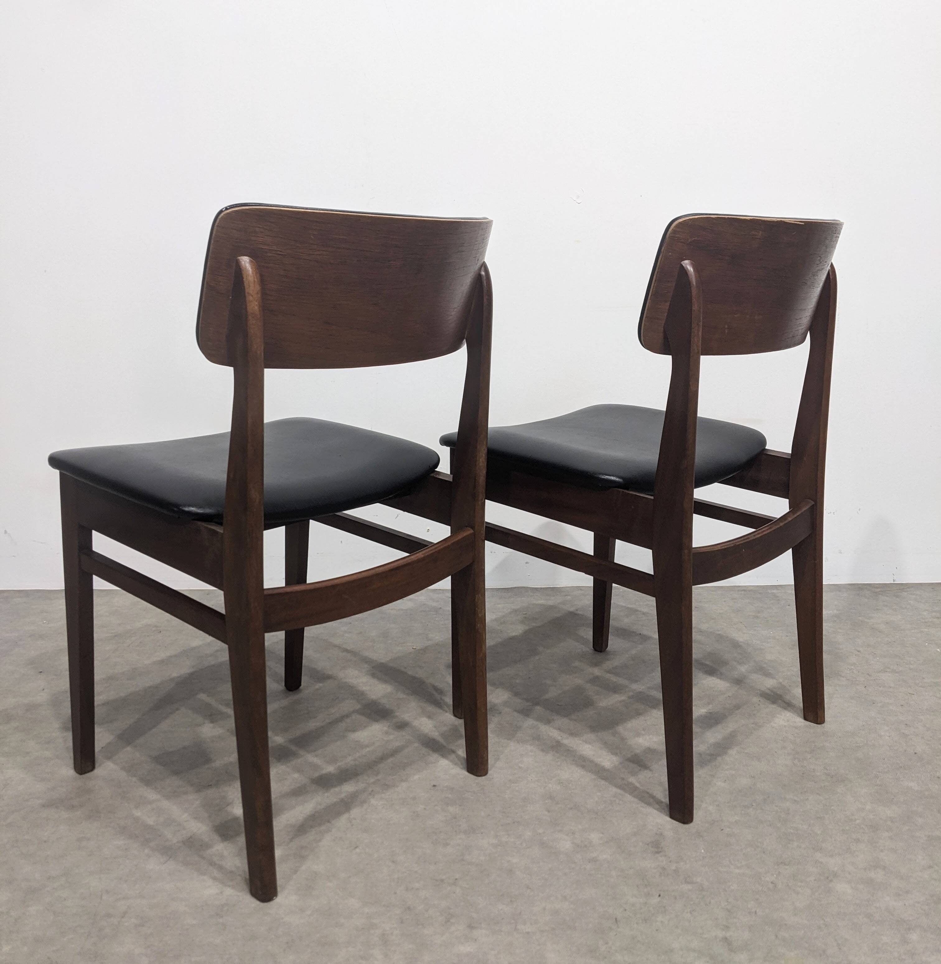 Two mid-century faux leather chairs