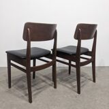 Two mid-century faux leather chairs
