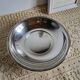 Shallow round metal plate with pearl row decoration.