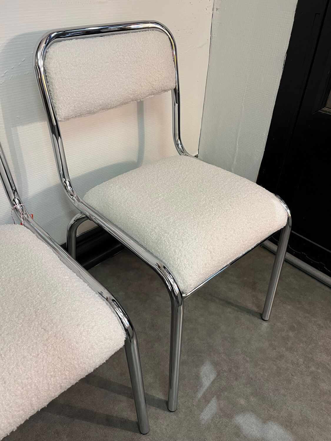 Pair of chrome chairs upholstered in boucle fabric.