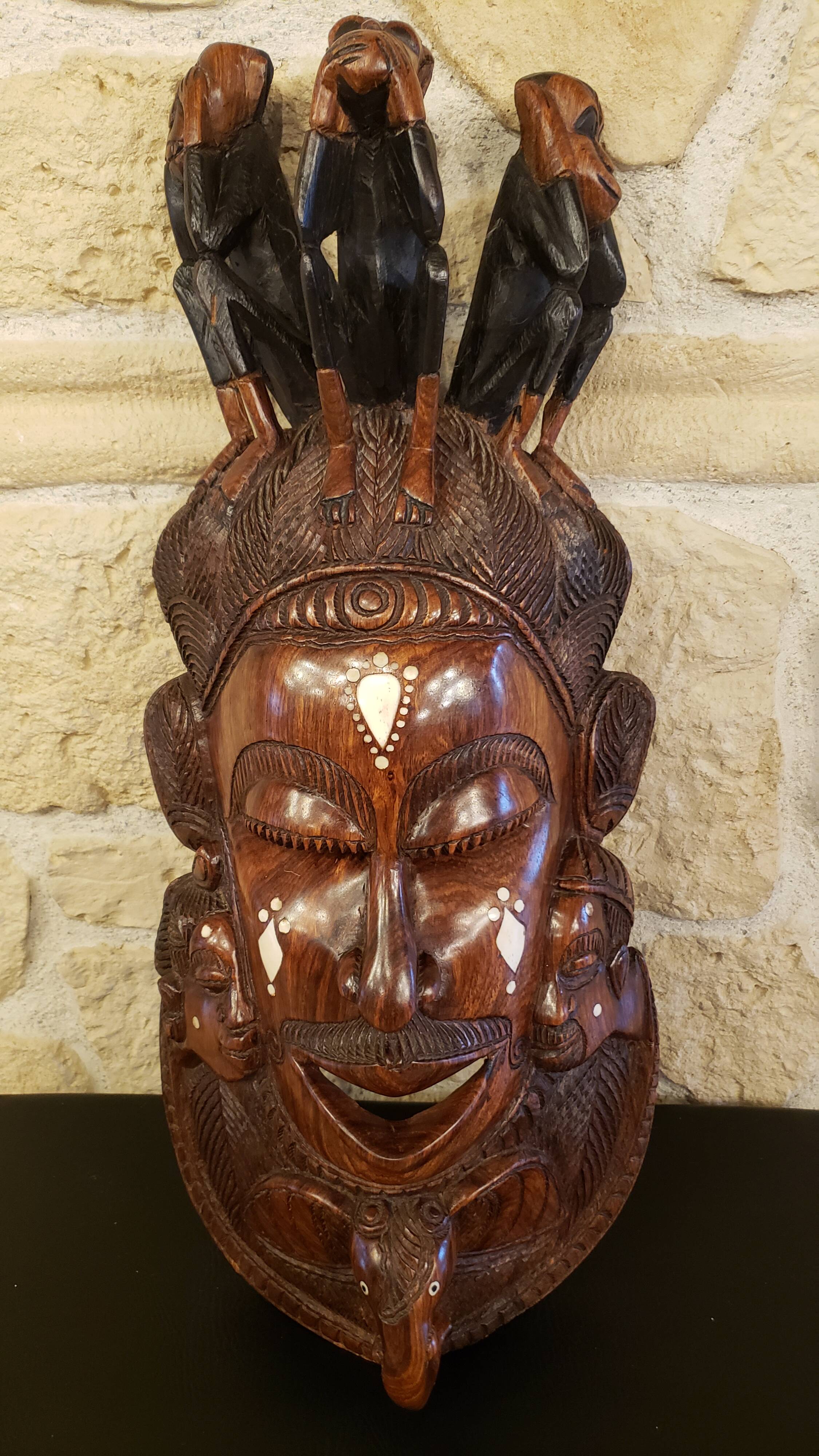 Old large African wall mask in carved wood