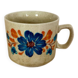 Speckled stoneware cup with blue flower