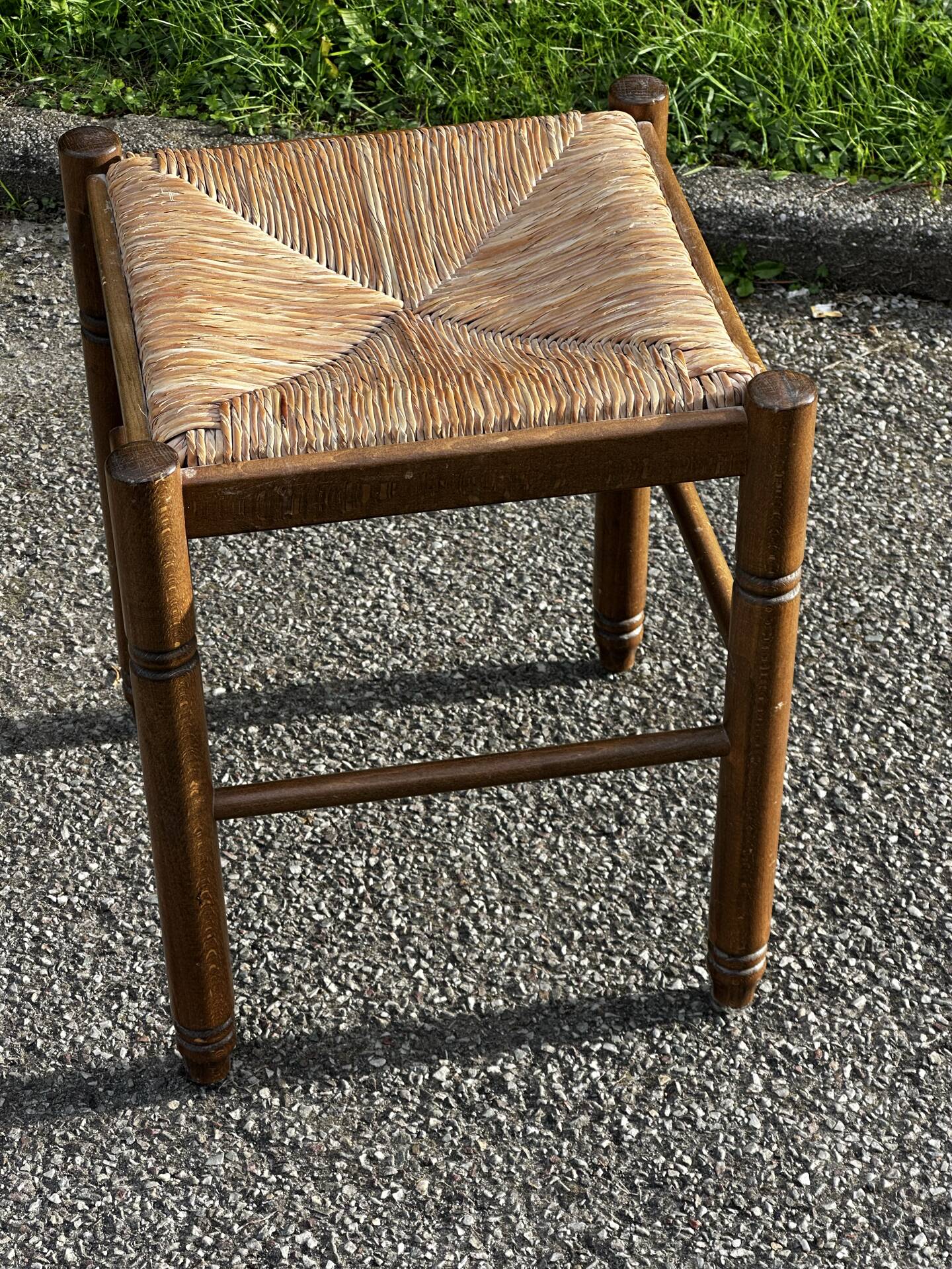 1950s turned wooden stool with a straw seat.