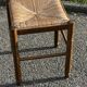 1950s turned wooden stool with a straw seat.